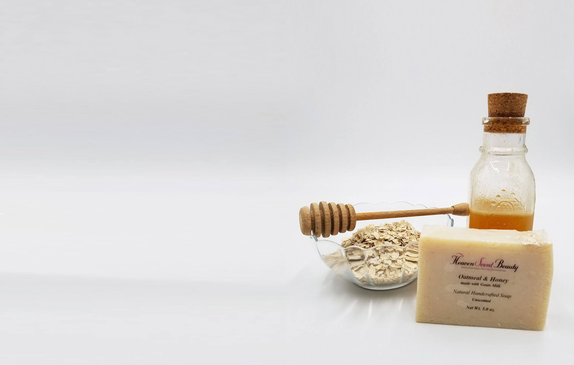 Handmade oatmeal and honey soap bar with honey dipper and jar